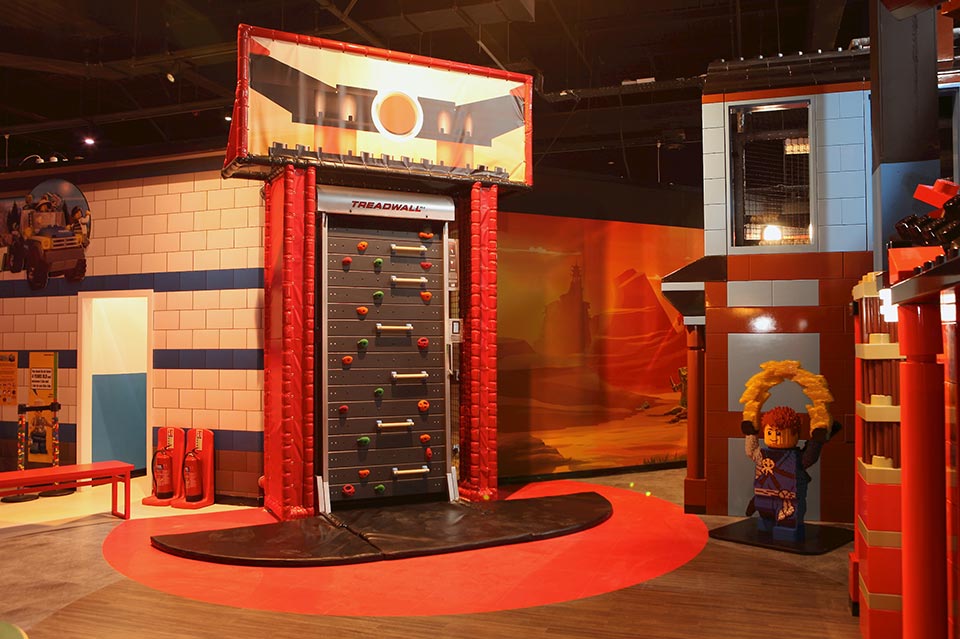 Interactive Lego exhibit featuring a large, detailed door and colourful surroundings designed for children’s play and exploration in a museum setting.