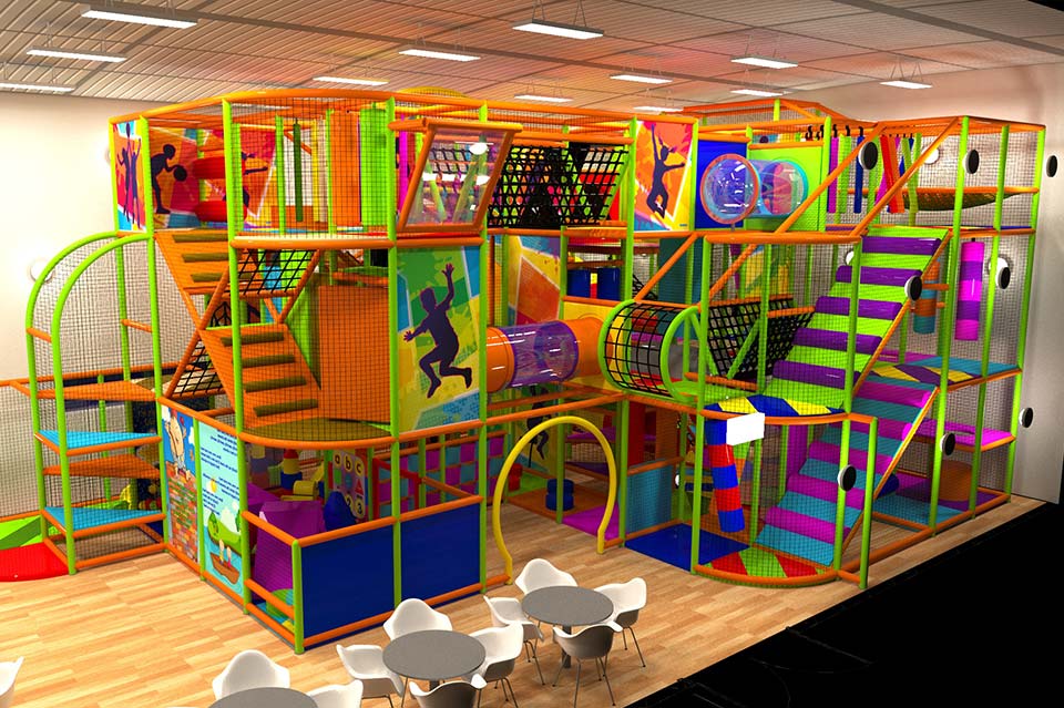 Bright and colourful indoor play area featuring multi-level climbing frames, slides, and interactive play structures for children, with tables and chairs for parents in the foreground.