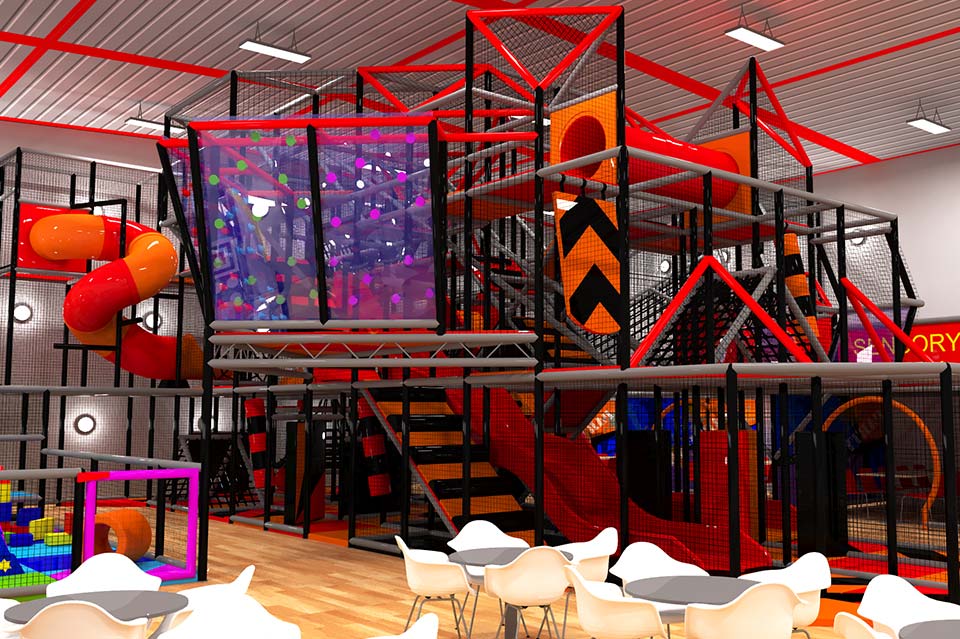 Indoor play area featuring a multi-level climbing structure with vibrant red and black colours, interconnected slides, and various play elements. The space includes seating areas for parents and observers, creating an engaging environment for children to play and explore.