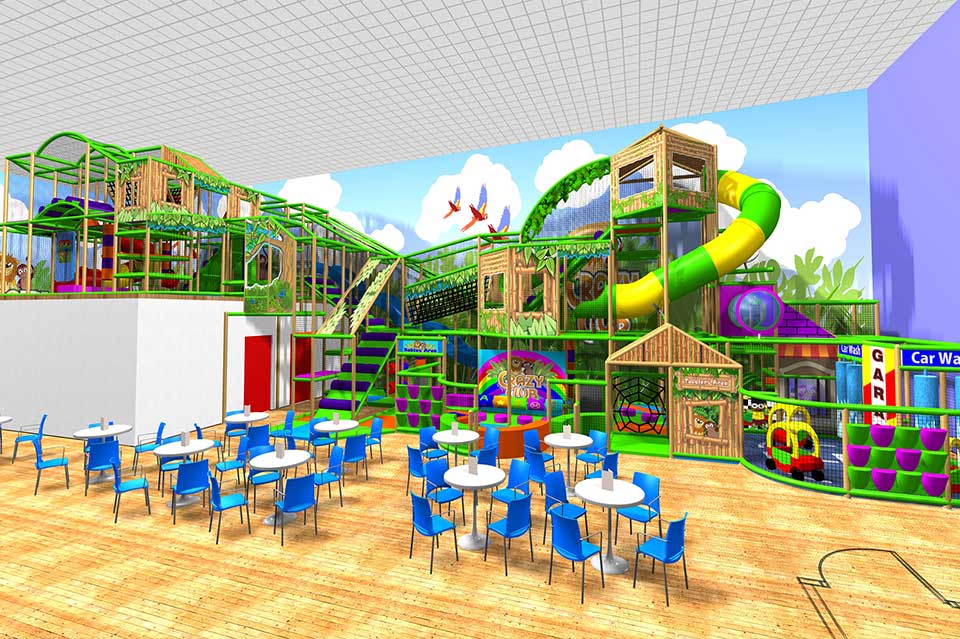 Indoor children's play area featuring vibrant green climbing structures, a large slide, and colourful murals. Tables and chairs in blue are arranged for seating, creating a welcoming environment for kids to play and socialise.