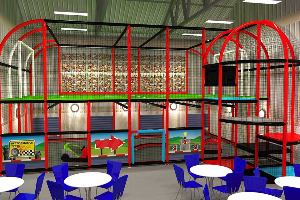 Indoor play area featuring a multi-level climbing frame with slides and colourful decor, surrounded by blue tables and chairs for parents. Ideal for children's entertainment and active play.
