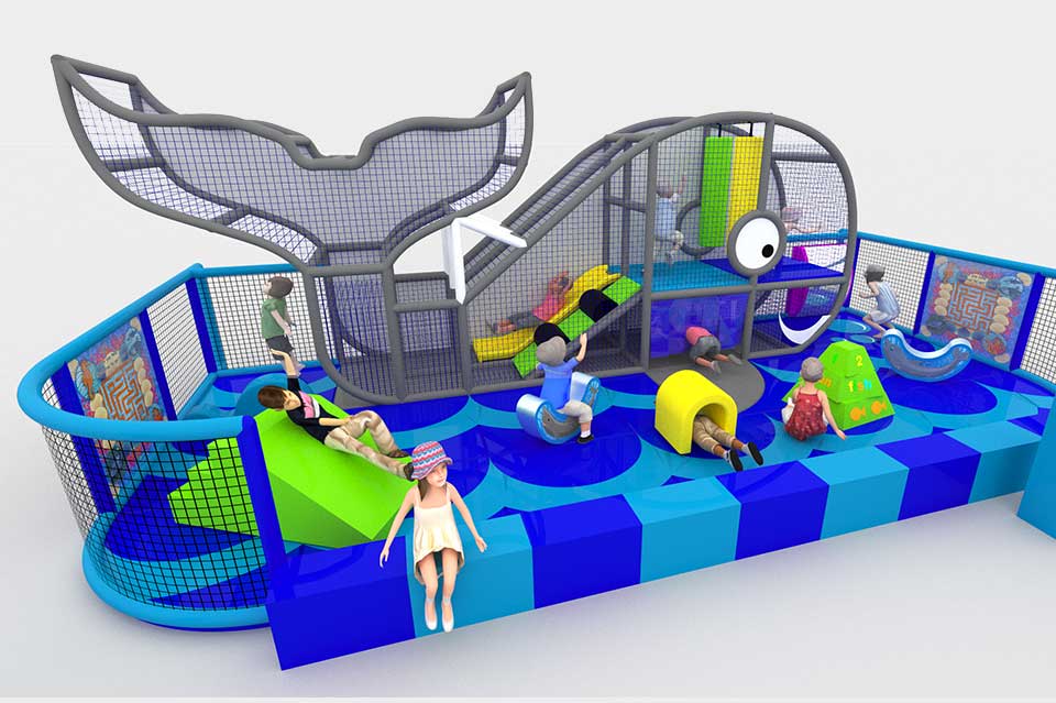 Colourful indoor play area featuring a whale-themed climbing structure, slides, and various play equipment. Children are engaged in different activities, including sliding, climbing, and exploring, in a safe and vibrant environment designed for fun and physical activity.